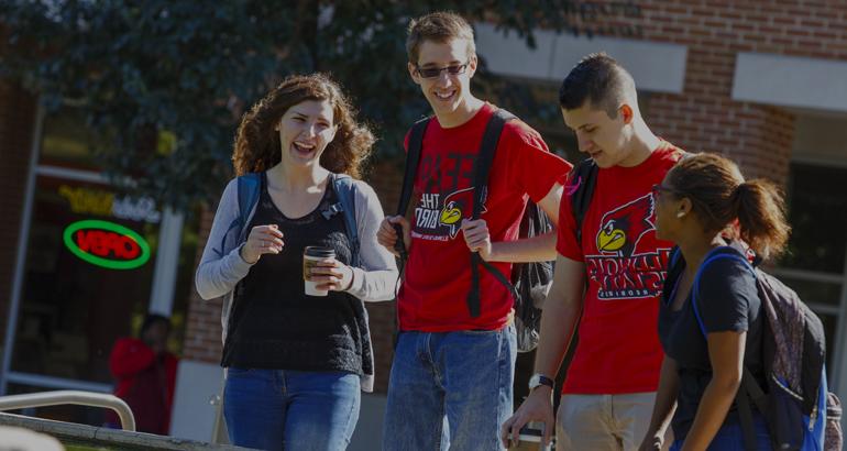 学生 laughing as they walk to class.